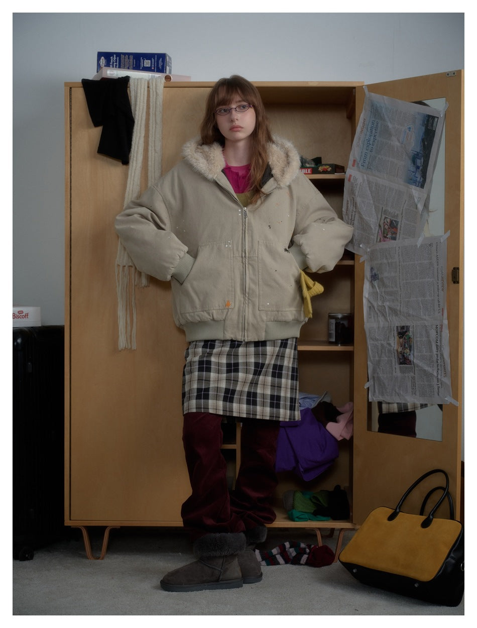 Full-length model wearing a light beige plush-collar zip jacket over a black-and-white plaid skirt.