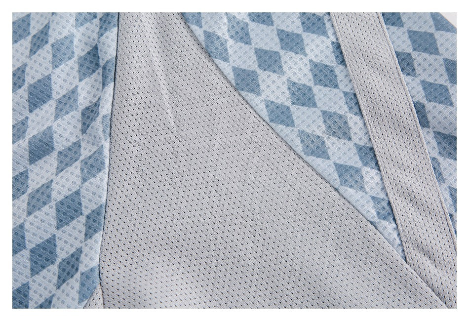 Close-up showing the blue patterned jersey fabric beside a pale perforated mesh panel and trim.