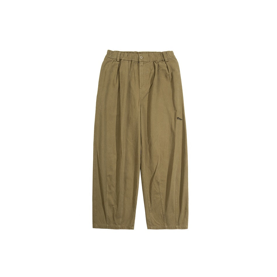 Khaki wide-leg pants with elastic waistband, front button and small embroidered logo, flat lay on white