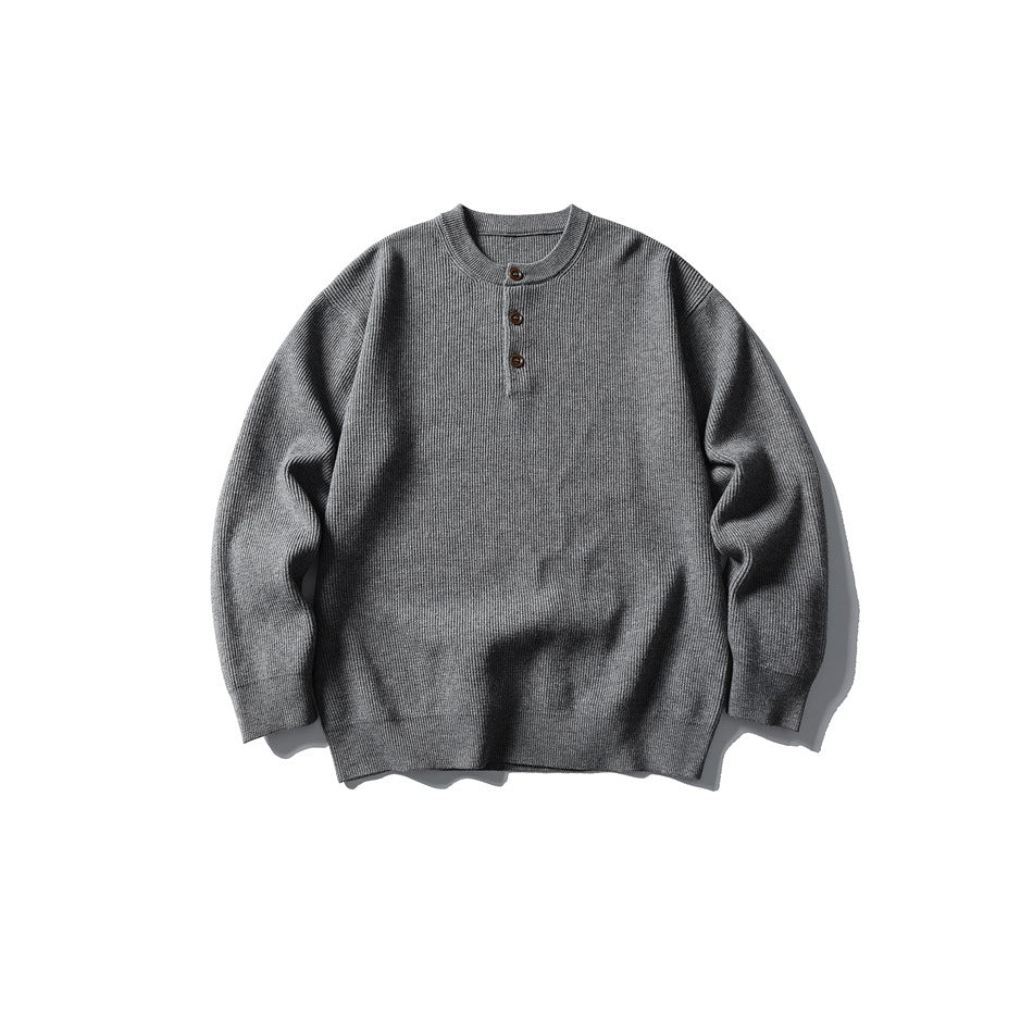 Gray ribbed-knit Henley sweater with three brown buttons, flat lay front view