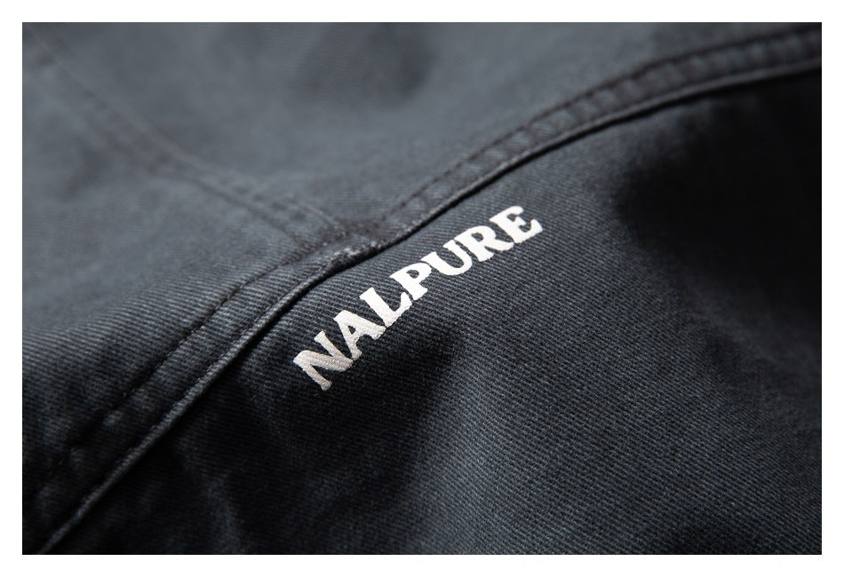 Close-up of white NALPURE lettering printed on dark charcoal fabric.