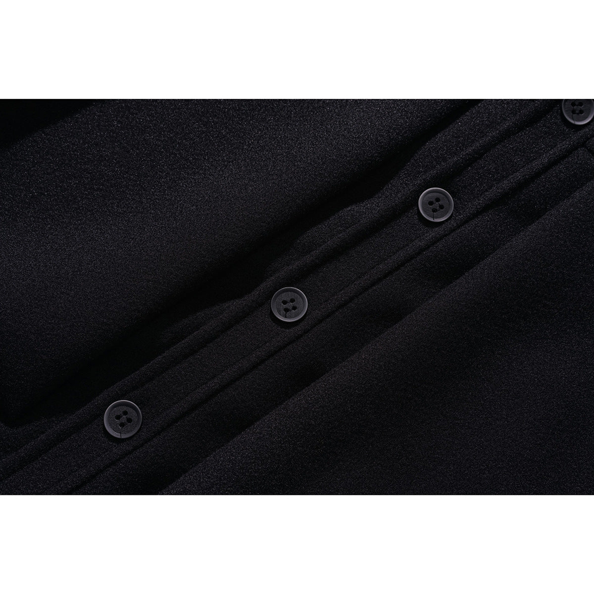 Close-up of a black jacket's buttoned front placket with several dark four-hole buttons.