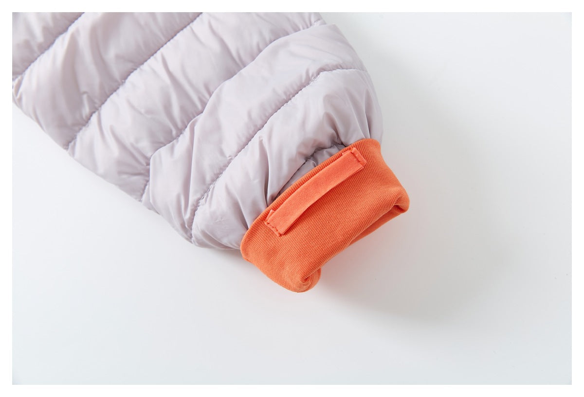 Close-up of the jacket sleeve's orange ribbed cuff and adjustable strap.