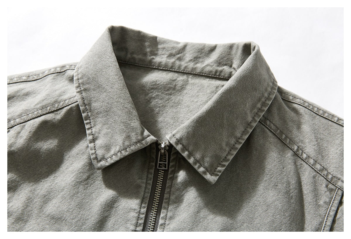 Close-up of the gray washed jacket's pointed collar and central metal zipper.