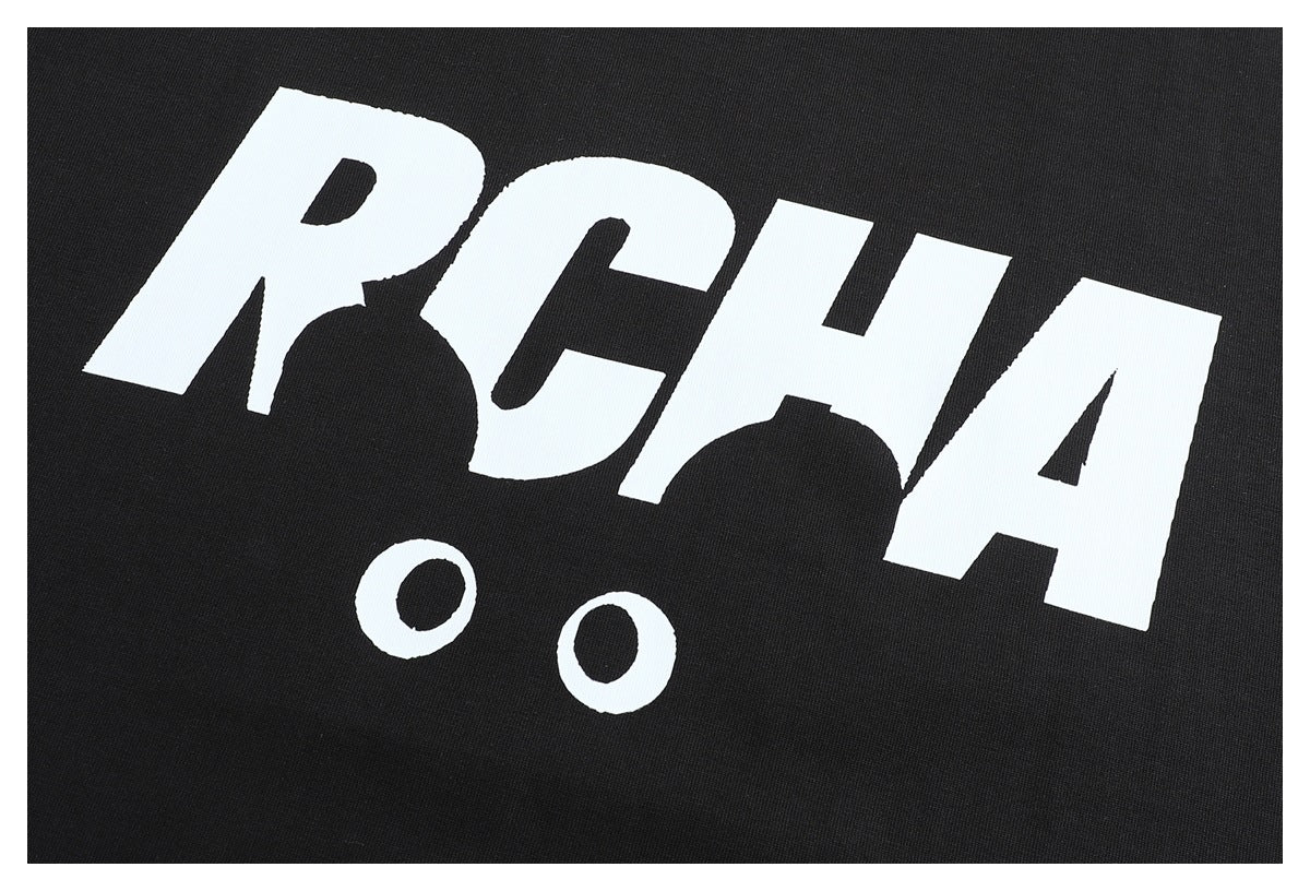 Close-up of bold white lettering and two circles printed on black T-shirt fabric.