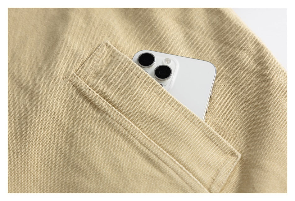 A white phone peeks from a diagonal pocket in beige woven fabric.