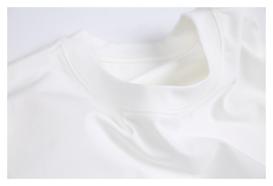 Close-up of a white crew neckline with ribbed trim and visible stitching.