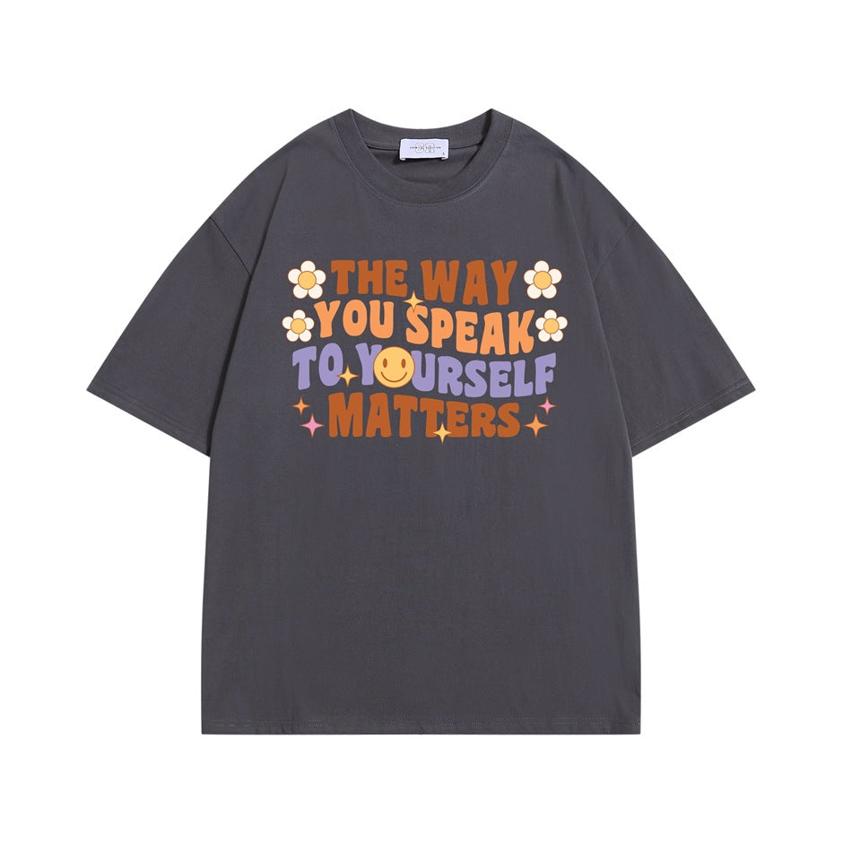 Gray short-sleeve T-shirt with colorful retro slogan print, daisies and smiley face on the chest