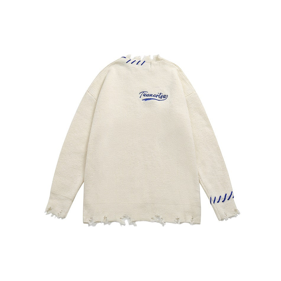 Ivory knit sweater with distressed edges, blue stitch accents, and matching script embroidery on the chest.