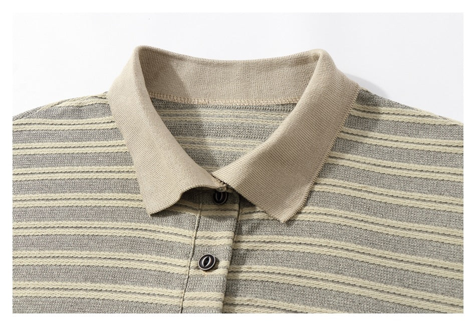 Close-up of a beige polo collar and button placket on a gray and cream striped shirt.