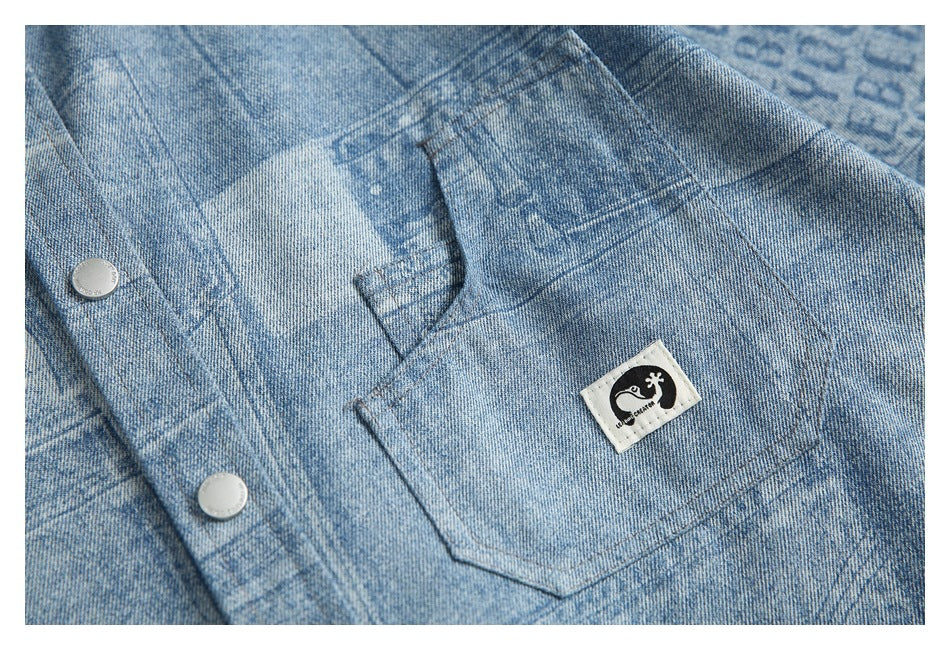 Close-up of the light blue patterned shirt's chest pocket with a sewn emblem patch and silver snap buttons.