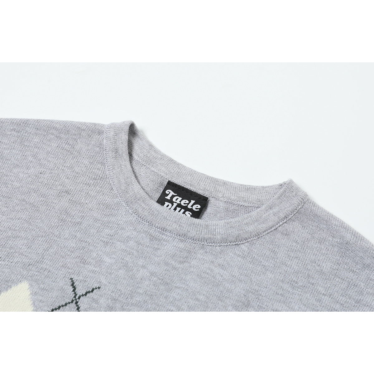 Close-up of the gray knit crew neckline and a black sewn-in label.