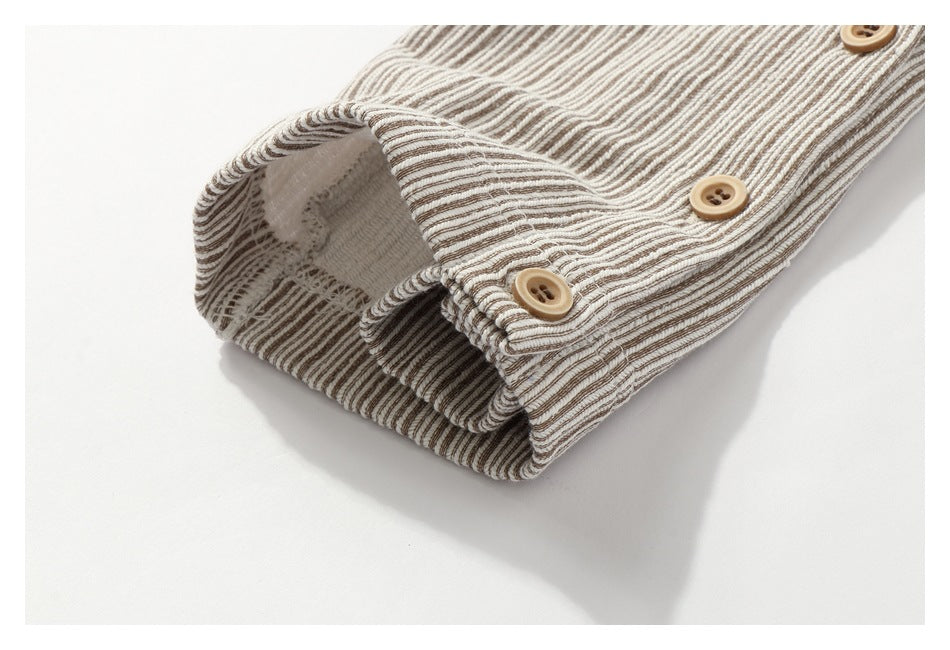Close-up of a beige-and-brown striped cuff with three tan buttons.