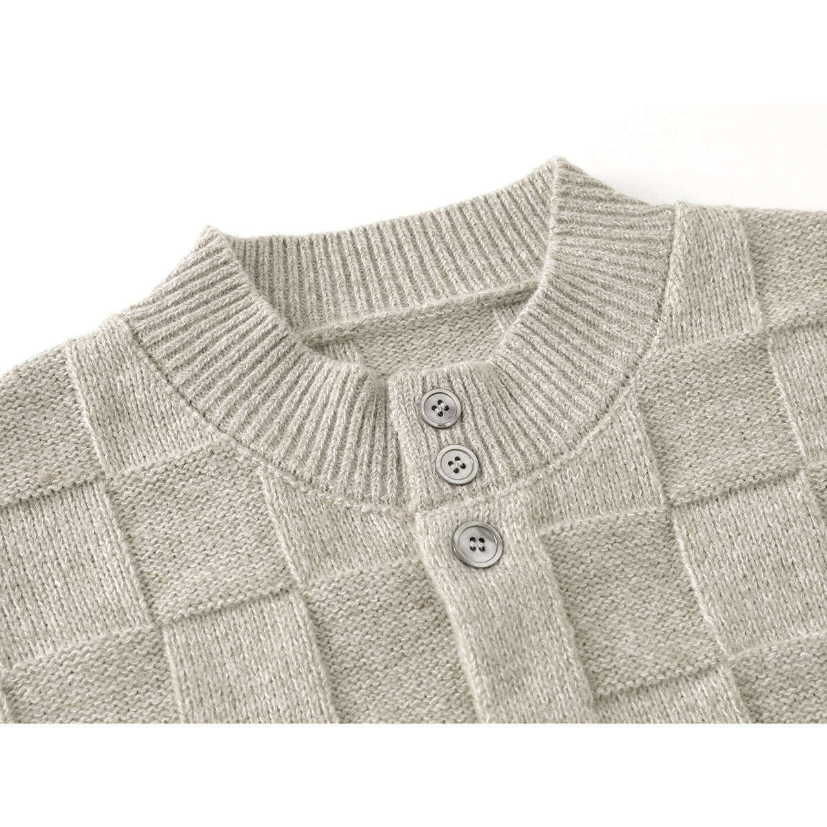 Close-up of a light beige knit cardigan showing its ribbed stand collar, button placket, and textured pattern.