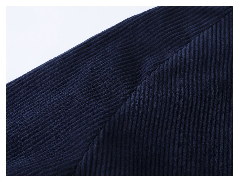Close-up of dark navy ribbed garment fabric with a diagonal seam.