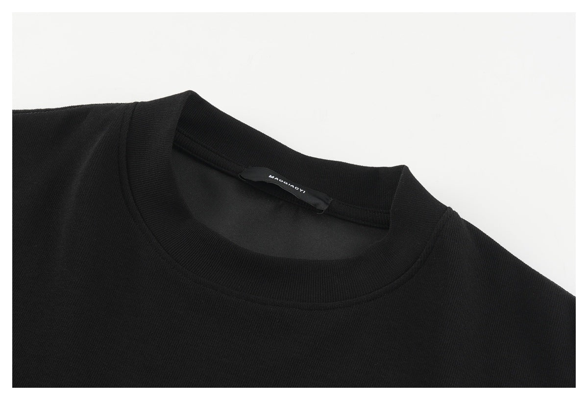 Close-up of a black crew neckline with a ribbed collar and a small label inside.