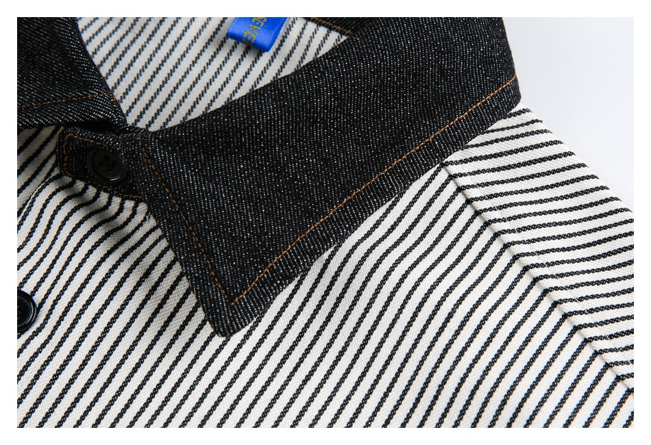 Close-up of a dark contrast collar with brown stitching on a black-and-white striped shirt.