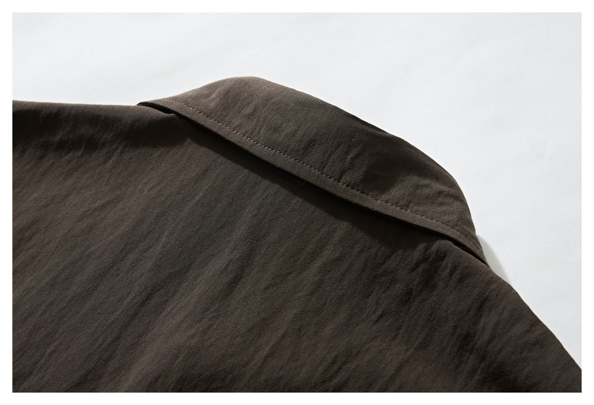 Close-up of the dark brown shirt’s back shoulder and collar seam.