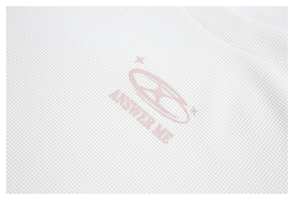 Close-up of white waffle-knit fabric with a pale pink printed emblem and lettering.