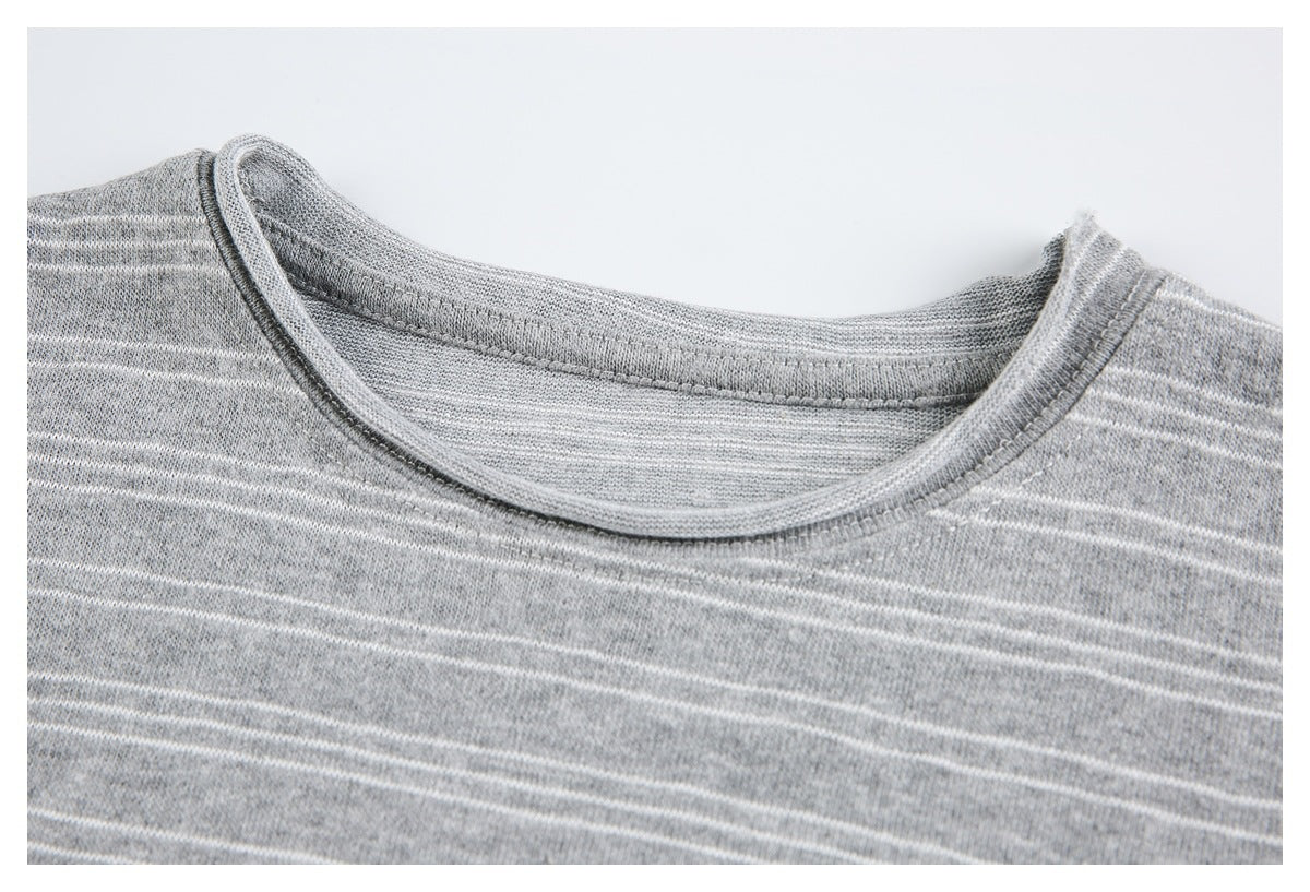 Close-up of the round neckline and thin white stripes on a heather gray top.