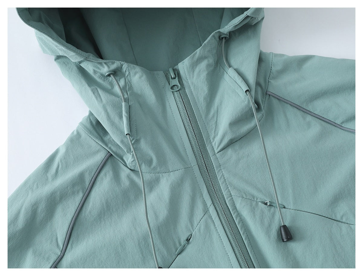 Close-up of a pale teal jacket hood, front zipper, and adjustable drawcords.