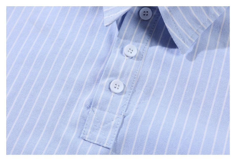 Close-up of the light blue striped shirt's collar and three-button placket.