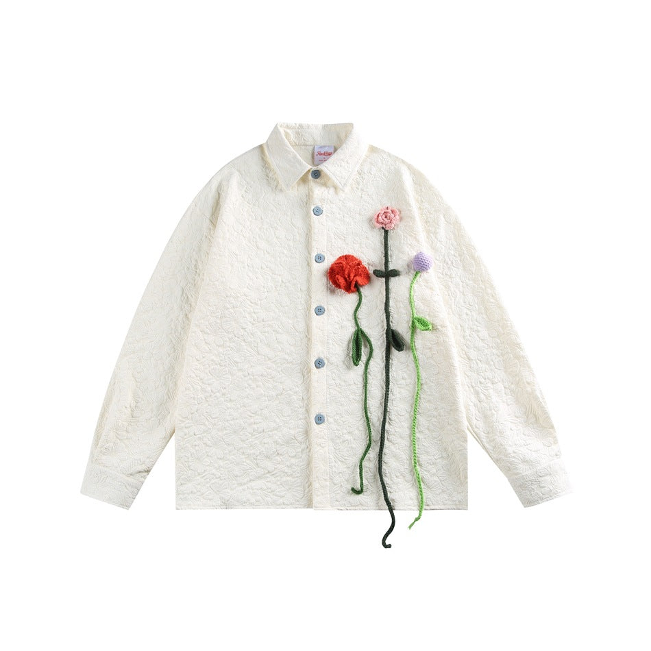 Front view of an ivory textured button-front jacket with colorful three-dimensional flower appliqués.