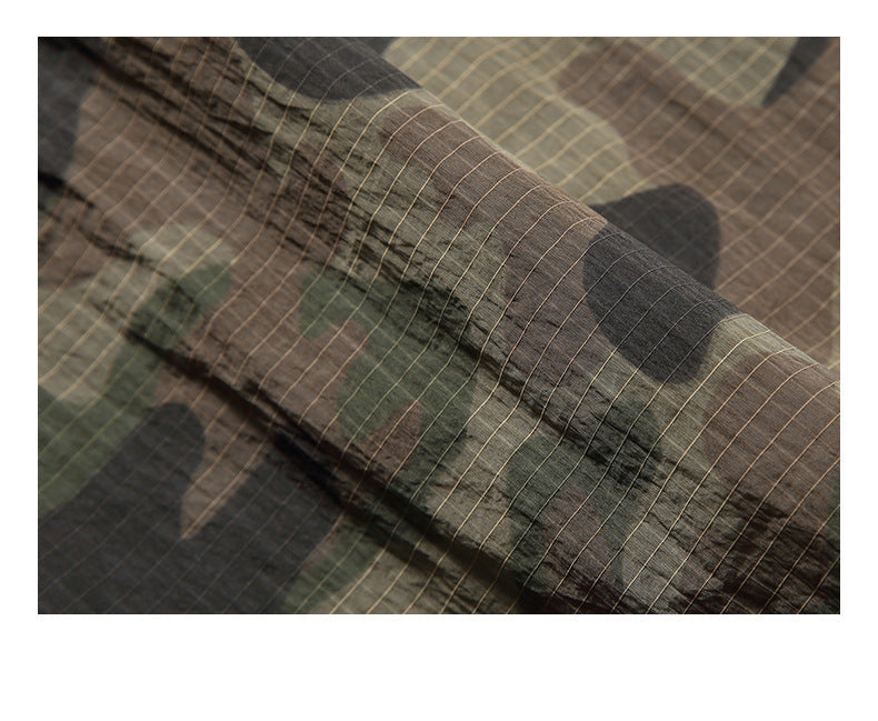 Close-up showing the fine grid texture and camouflage pattern of the fabric.