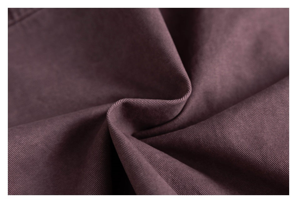Close-up showing the fine diagonal weave and soft folds of dusty mauve fabric.
