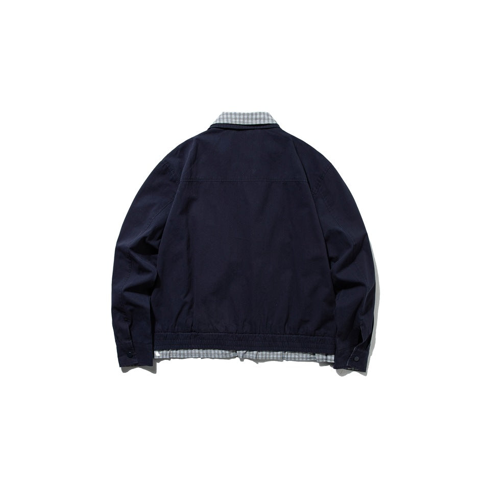 Back view of navy jacket flat lay with back yoke seam, elastic hem, button cuffs and check layer at the hem