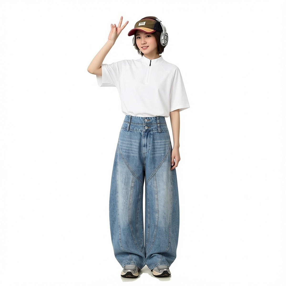 Model wearing light blue wide-leg jeans with curved panel seams and a white short-sleeve zip-neck top.