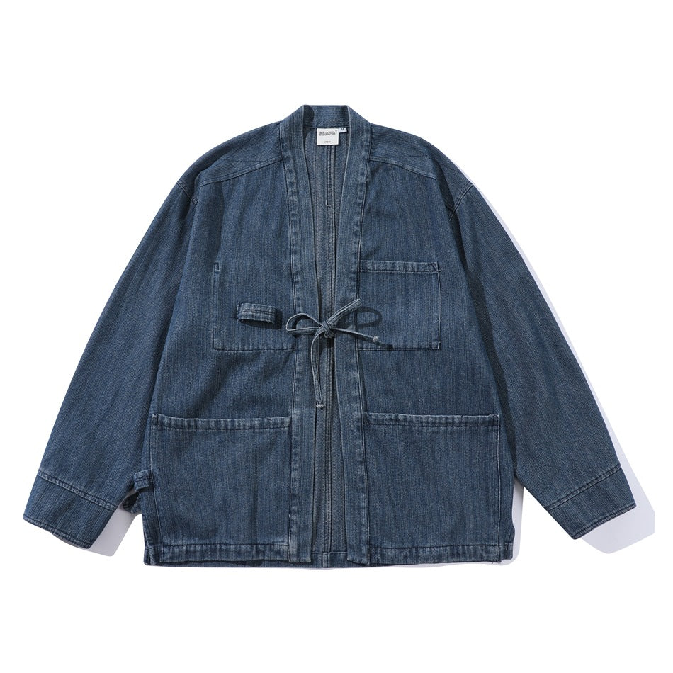 Blue washed denim kimono-style jacket flat lay with open front, tie cord and three patch pockets