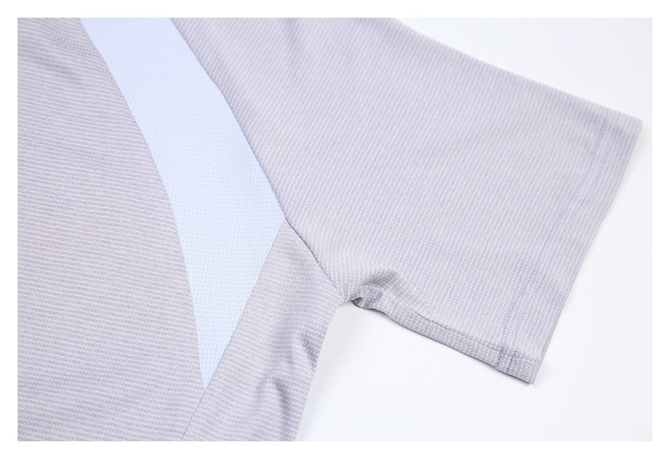 Close-up of a short sleeve and pale perforated insert on a light gray-lilac shirt.