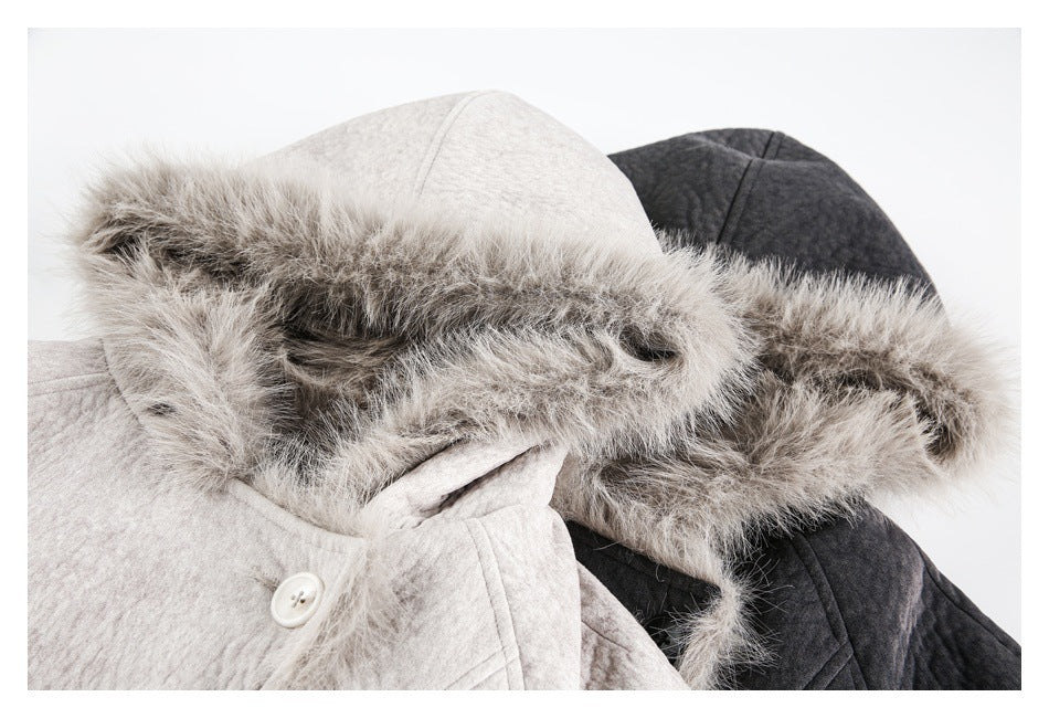 Close-up of fur-trimmed hoods on light gray and charcoal jackets, showing the plush trim and button detail.