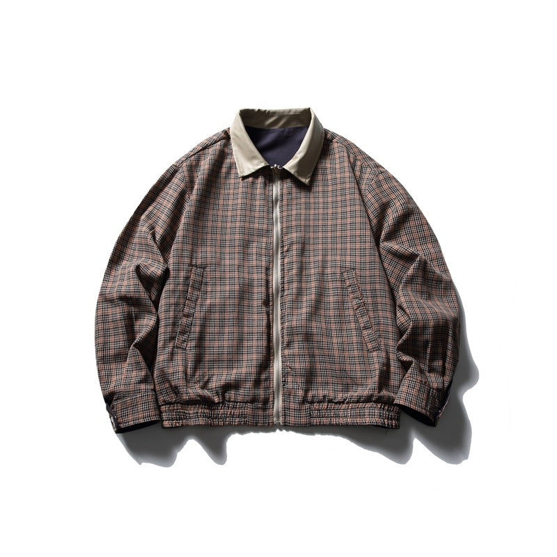 Front view of an orange-brown and dark plaid jacket with a beige collar, front zipper, angled pockets and gathered hem.