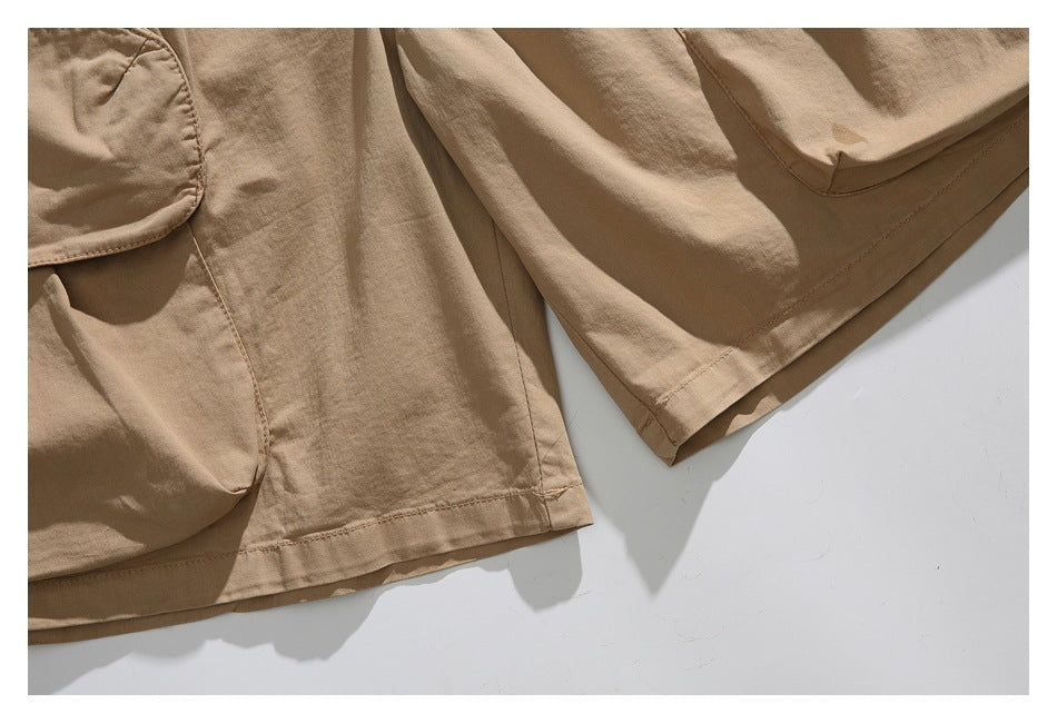 Close-up of the tan shorts' leg openings, hems, and stitching.
