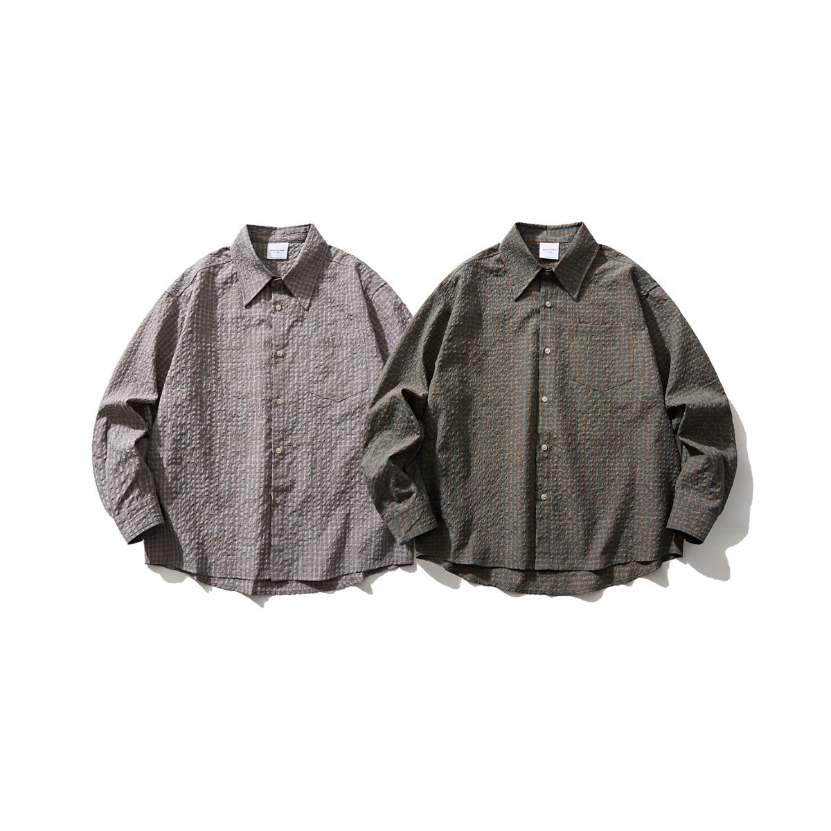 Two long-sleeve button-up shirts laid flat: one gray plaid and one dark teal-brown patterned.