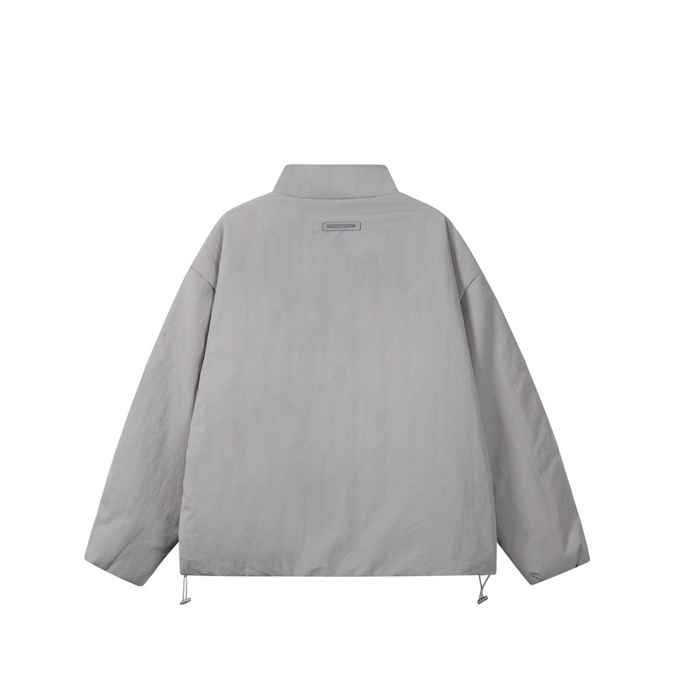 Back of a light gray jacket with a high collar, dropped shoulders, and adjustable drawcords at the hem.
