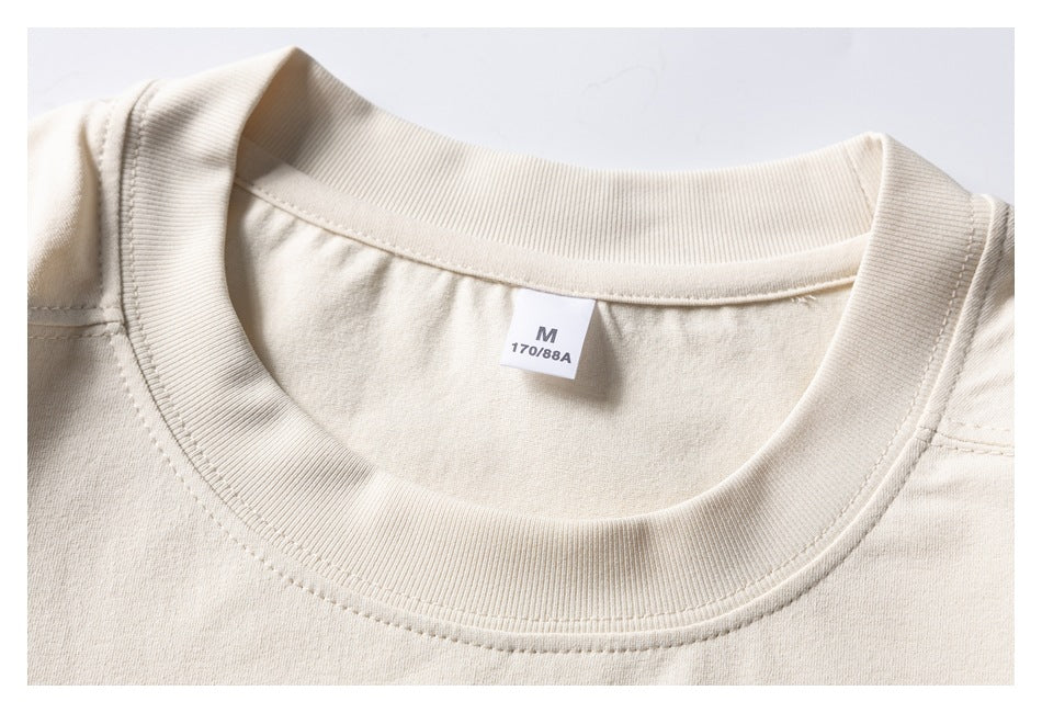 Close-up of an ivory crewneck shirt neckline with a visible size label marked M and 170/88A.