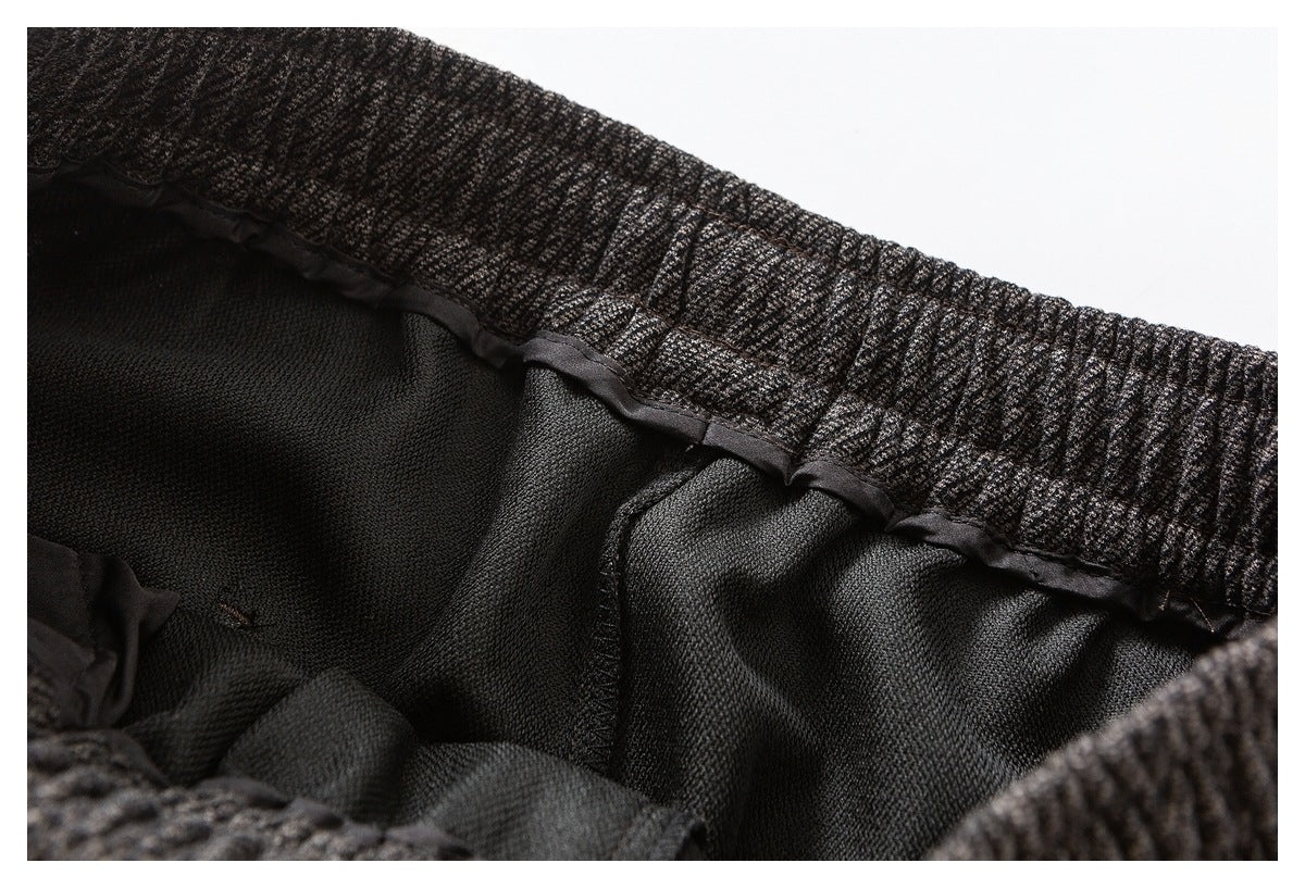 Close-up of a dark patterned elastic waistband and black interior stitching.