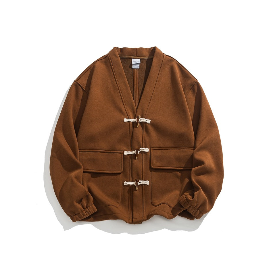 Caramel brown V-neck jacket with three toggle closures and two flap pockets, flat lay