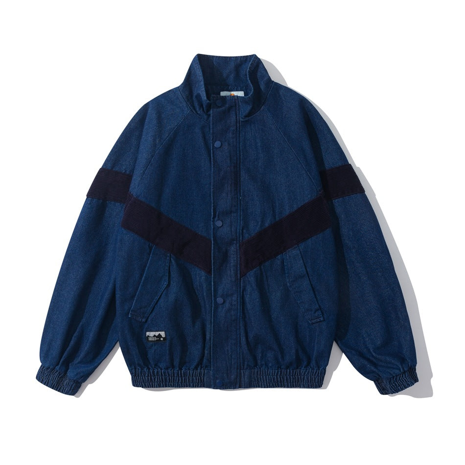 Front view of a blue jacket with a stand collar, snap-button placket, dark diagonal bands, pockets, and elastic cuffs and