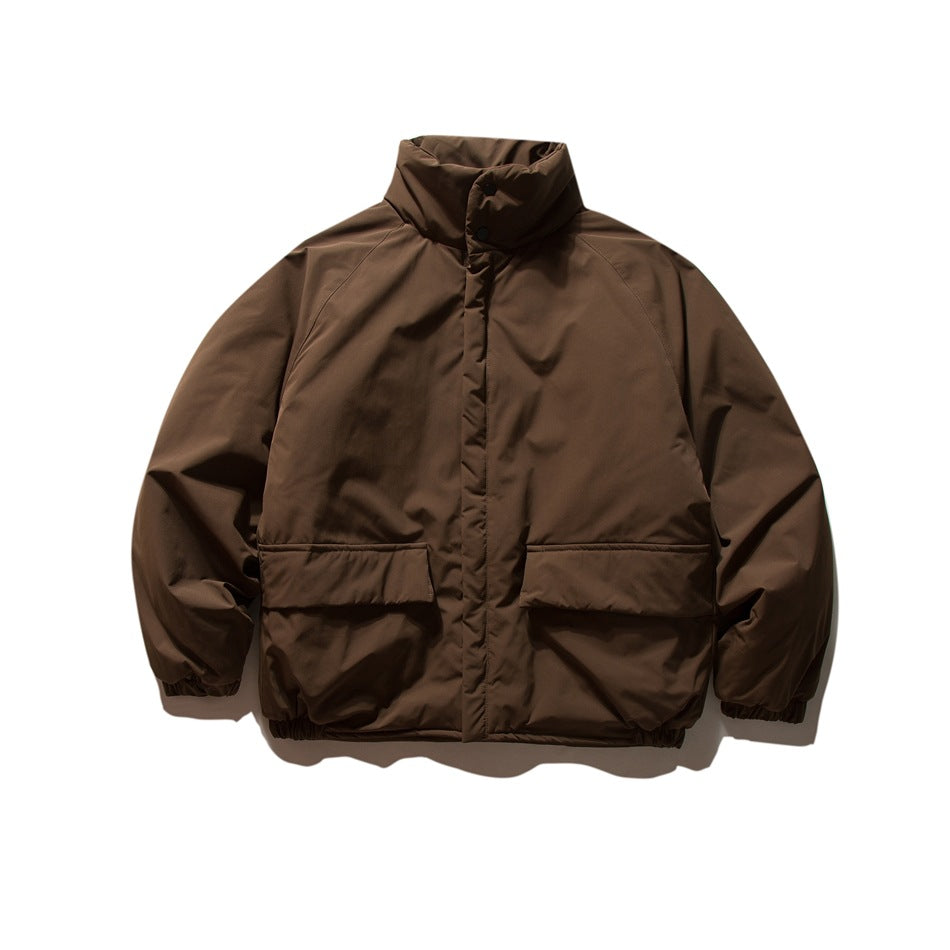 Brown oversized stand-collar puffy jacket with two flap pockets and elastic cuffs, front flat view