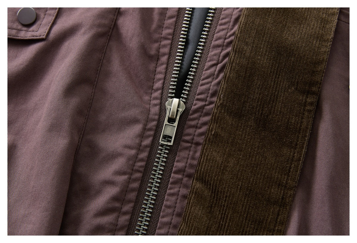 Close-up of a mauve-brown jacket zipper with a metal pull and dark brown ribbed trim.