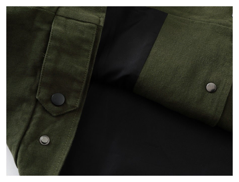 Close-up of dark olive garment panels with a snap-fastened flap and metal snaps.