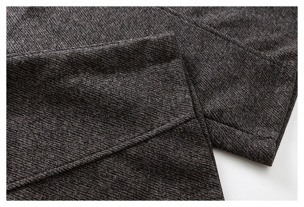 Close-up of charcoal gray marled pants showing a folded seam and fabric construction.