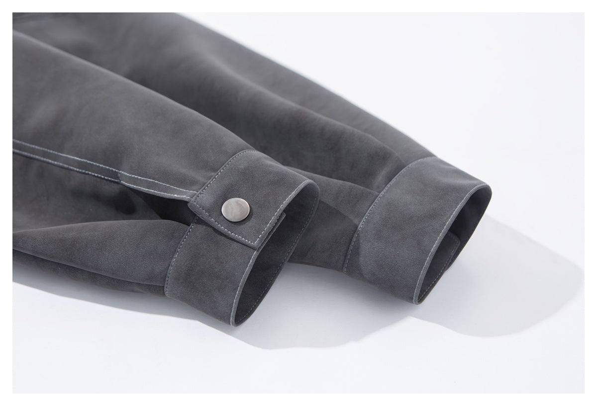 Close-up of the jacket's sleeve cuffs, showing a snap-button tab and stitched edges.