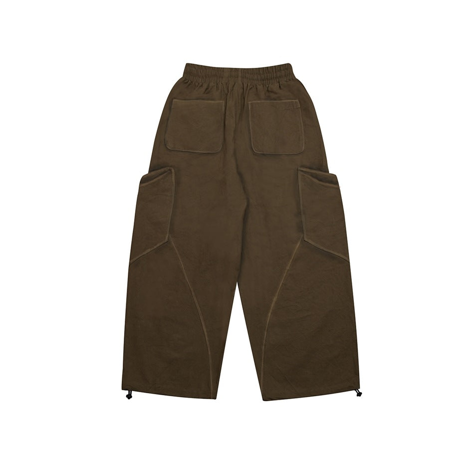 Back view of olive-brown cargo pants laid flat, with an elastic waist, two rear pockets and large side pockets.