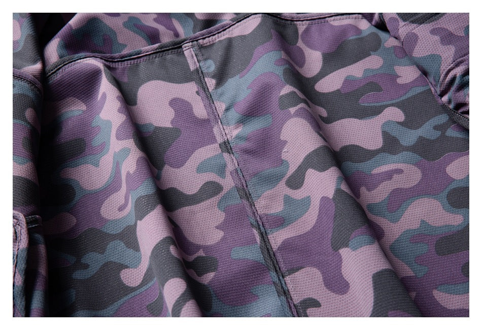 Close-up of purple, gray, and teal camouflage fabric with a stitched seam.