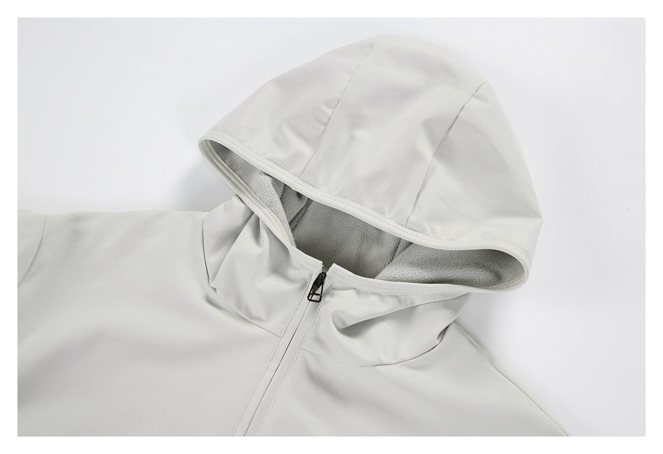 Close-up of an off-white jacket hood with gray lining and a front zipper.